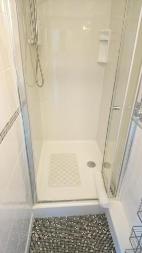 a bathroom with a shower with a glass door at The Great Western B&B in Paignton
