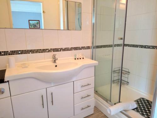 a bathroom with a sink and a shower at The Great Western B&B in Paignton