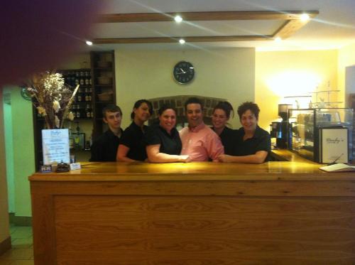 a group of people standing at a counter at Bridge View Guest House in Ironbridge