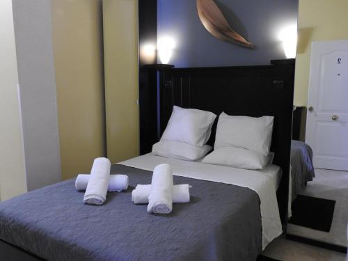 a bed with two rolls of towels on it at Las Flores studio 2 in Playa de las Americas