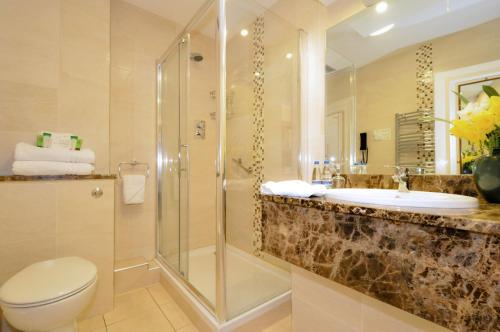 a bathroom with a sink and a shower and a toilet at The Ardilaun Hotel in Galway