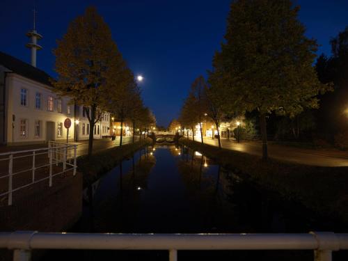a canal in a city at night at Best Western Plus Hotel Papenburg in Papenburg