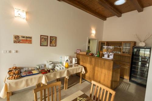 a kitchen with two tables with food on it at Penzion Jelen Vranov nad Dyjí in Vranov nad Dyjí