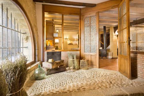 een kamer met een tafel met vazen en een raam bij Posada de Uncastillo in Uncastillo