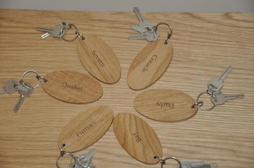a group of wooden key chains on a table at Bridge View Guest House in Ironbridge