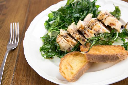 a white plate of food with a salad and bread at TENUTAYALA - Residenza Agrituristica in Parabita