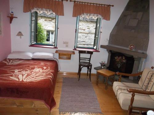 a bedroom with a bed and a fireplace at Lakis Rooms in Papigko