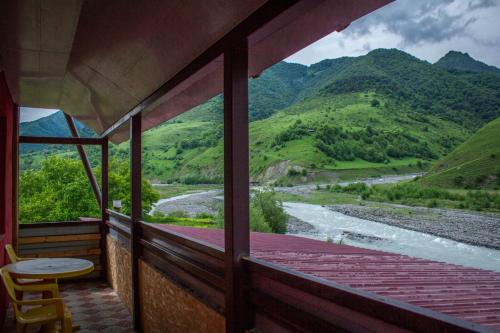 a room with a view of a river and mountains at ''Aragvi'' hotel in Naghorevi