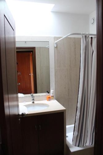 a bathroom with a sink and a mirror at Matosinhos -Seas Apartment- Cabo das Marés in Matosinhos