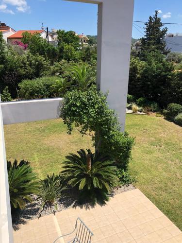 a bench sitting on a patio with a garden at Villa Evi in Ixia