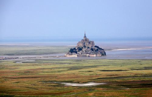 an island in the middle of the ocean with a castle at Altos Hotel & Spa in Avranches