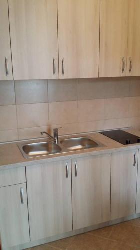 a kitchen with white cabinets and a sink at Guesthouse Vujacic in Cetinje