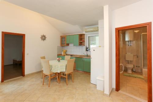 a kitchen and dining room with a table and chairs at Apartments Laguna 2 in Bol