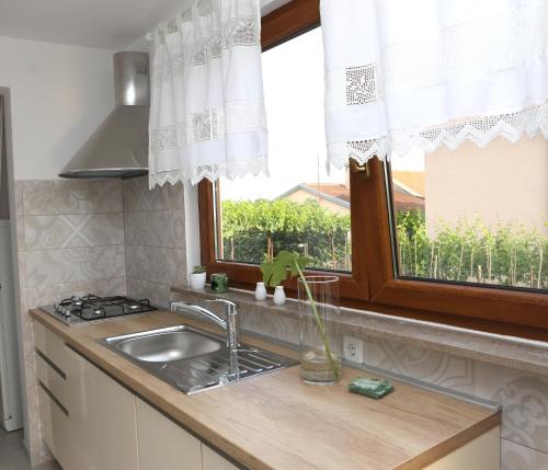 a kitchen with a sink and a window at Garden in Pula