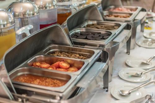 a row of trays of food on a table at Ben Nevis Hotel & Leisure Club in Fort William