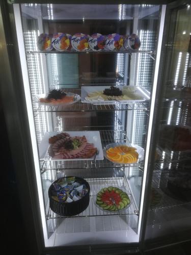a refrigerator filled with lots of different types of food at Hotel Altes Badehaus in Bad Dürrenberg