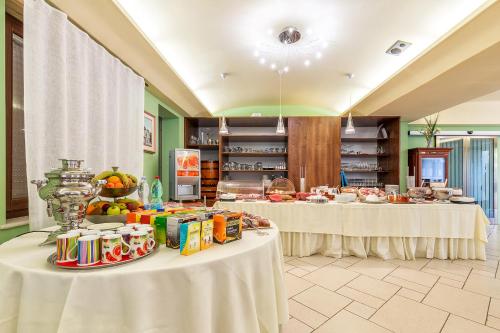 a room with two tables with food on them at Hotel Santa Maria in Santa Maria Navarrese