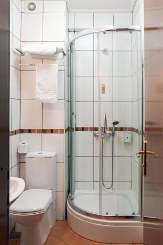 a bathroom with a toilet and a glass shower at Hotel Inter Istanbul in Istanbul