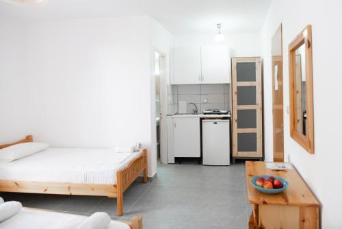 a small room with a bed and a table at Afroditi Pansion in Agios Nikitas