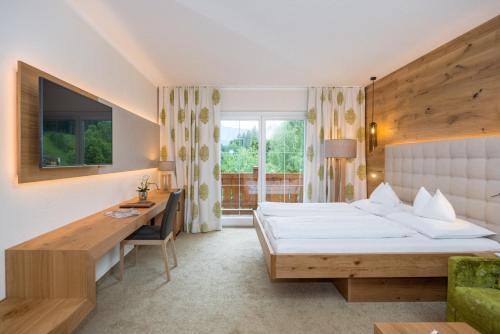 A bed or beds in a room at Hotel Ennstalerhof