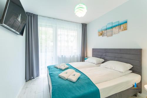 En eller flere senge i et værelse på 3L Apartments Bliżej Morza
