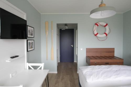 Ένα ή περισσότερα κρεβάτια σε δωμάτιο στο Havelhotel