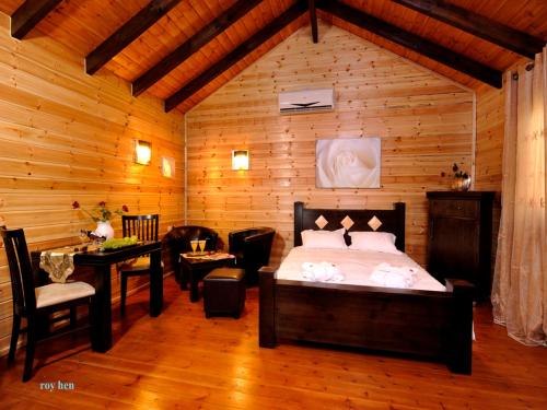 a bedroom with a bed and a table in a room at Good Zimmer With Love in Sede Terumot