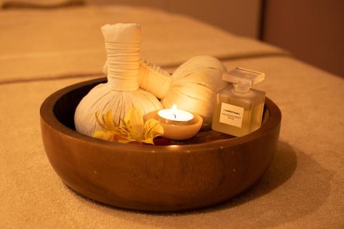a wooden bowl with a candle and other items on a bed at Crowne Plaza - Borjomi by IHG in Borjomi