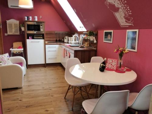 a kitchen with a white table and white chairs at Apartament Hawrań Murzasichle Apartamenty Murzasichle PL in Murzasichle