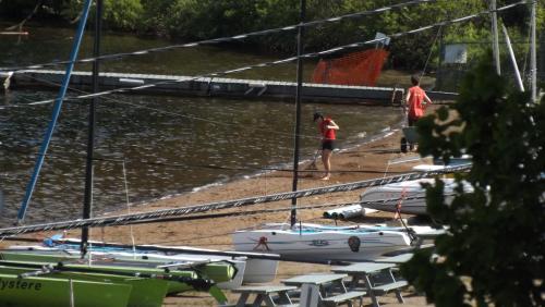 a group of boats sitting on the sand next to the water at Auberge Hotel Spa Watel in Sainte-Agathe-des-Monts