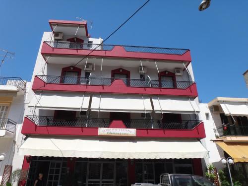 a red and white building with balconies at Papaioannou Aparts in Loutra Edipsou
