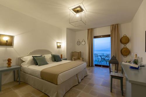 a bedroom with a bed and a view of the ocean at Romantic Relais Sorrento in Sorrento