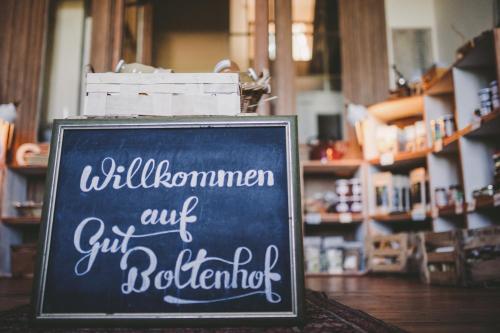 a chalkboard sign in front of a store at Gut Boltenhof in Fürstenberg-Havel