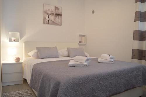 Posteľ alebo postele v izbe v ubytovaní Apartman Talija