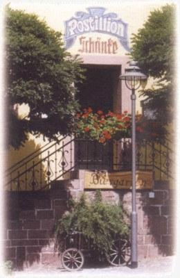 a building with a balcony with flowers on it at Landhotel Zur alten Post in Lohr am Main