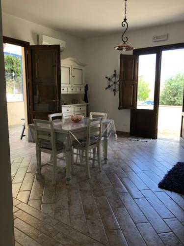 a kitchen with a table and chairs in a room at Baglio Mazzara in Custonaci