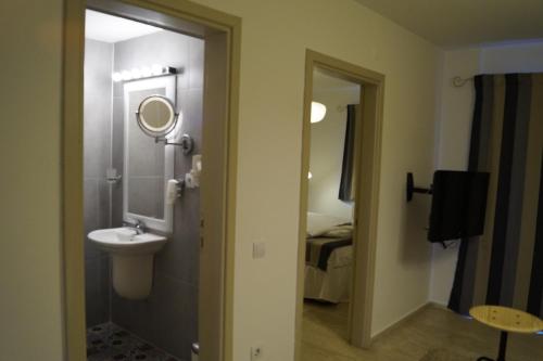 a bathroom with a sink and a mirror at Marina Sahil Hotel in Çeşme