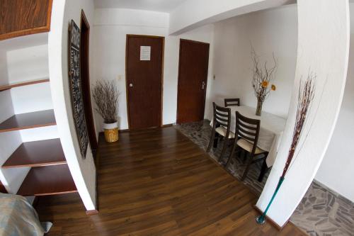a hallway with a table and chairs and a dining room at Hotel Bahamas in Montevideo