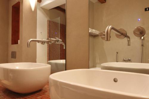 a bathroom with a white tub and a sink at Heritage Hotel Kukuriku in Kastav