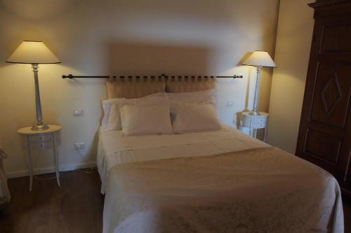 a bedroom with a large bed with two lamps at I Parigi Corbinelli Residenze in Florence