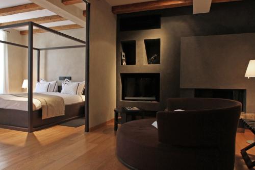 a bedroom with a bed and a tv and a couch at Heritage Hotel Kukuriku in Kastav