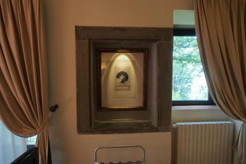 a mirror on a wall next to a window at I Parigi Corbinelli Residenze in Florence
