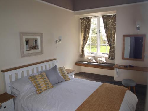 a bedroom with a bed and a window with a television at Red Lion in Exeter