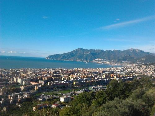 a view of a city with the ocean and mountains at Casa vacanze villa Pellegrino in Salerno