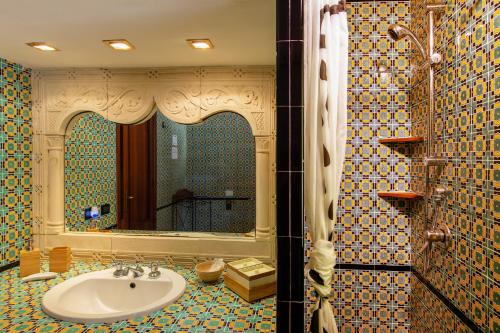 a bathroom with a sink and a mirror at Relais Le Nereidi in San Vito lo Capo
