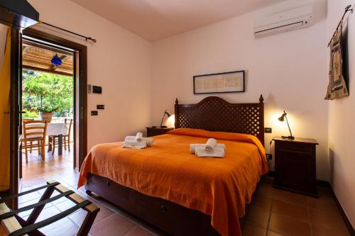 a bedroom with a bed with two towels on it at Relais Le Nereidi in San Vito lo Capo