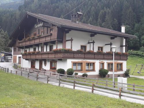 a house with a fence in front of it at Nieslerhof in Mayrhofen
