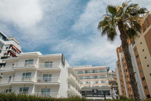 a palm tree in front of a white building at Soho Boutique Las Vegas in Málaga