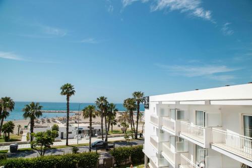 
a beach with palm trees and palm trees at Soho Boutique Las Vegas in Málaga
