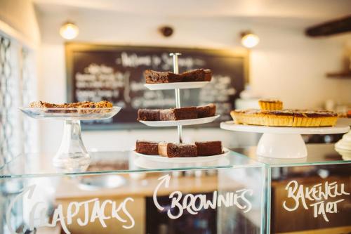 a display case with cakes and pies on display at Saltmarsh Farmhouse in West Dean